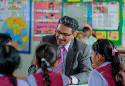 administrator speaking with children in a classroom